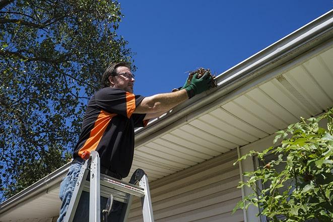 gutter repairman fixing a leaky drain in Tinley Park IL